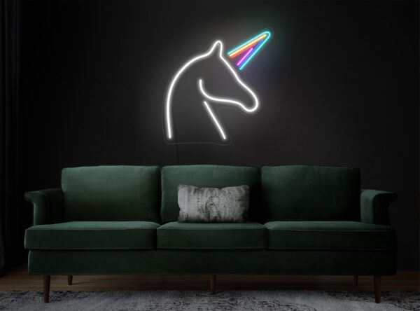 A glowing neon sign depicting the silhouette of a unicorn in vibrant colors, evoking whimsy and magic.