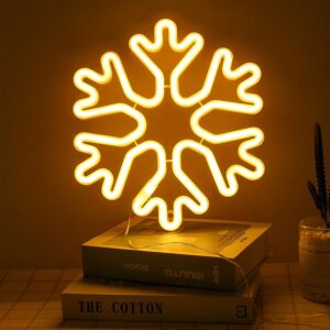 A glowing neon sign depicting a delicate snowflake in vibrant colors, evoking the magic of winter.