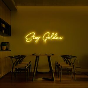 A glowing neon sign with the phrase 'Stay Golden' in vibrant colors, evoking warmth and elegance.