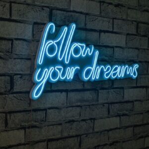 A glowing neon sign with the phrase 'Follow Your Dreams' in vibrant colors, evoking encouragement and aspiration.