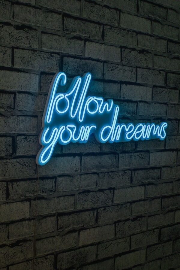 A glowing neon sign with the phrase 'Follow Your Dreams' in vibrant colors, evoking encouragement and aspiration.