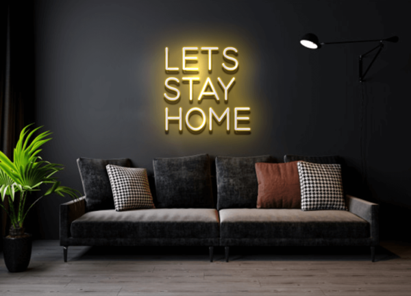 A glowing neon sign with the phrase 'Let's Stay Home' in vibrant colors, evoking warmth and relaxation.