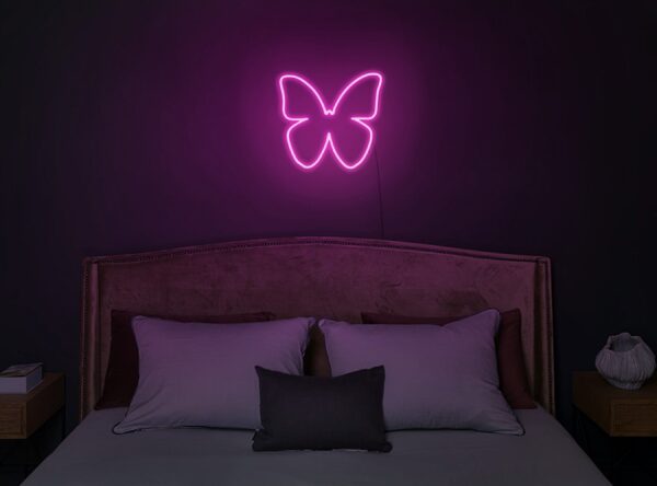 A glowing neon sign featuring a butterfly symbol in vibrant colors, evoking beauty and elegance.